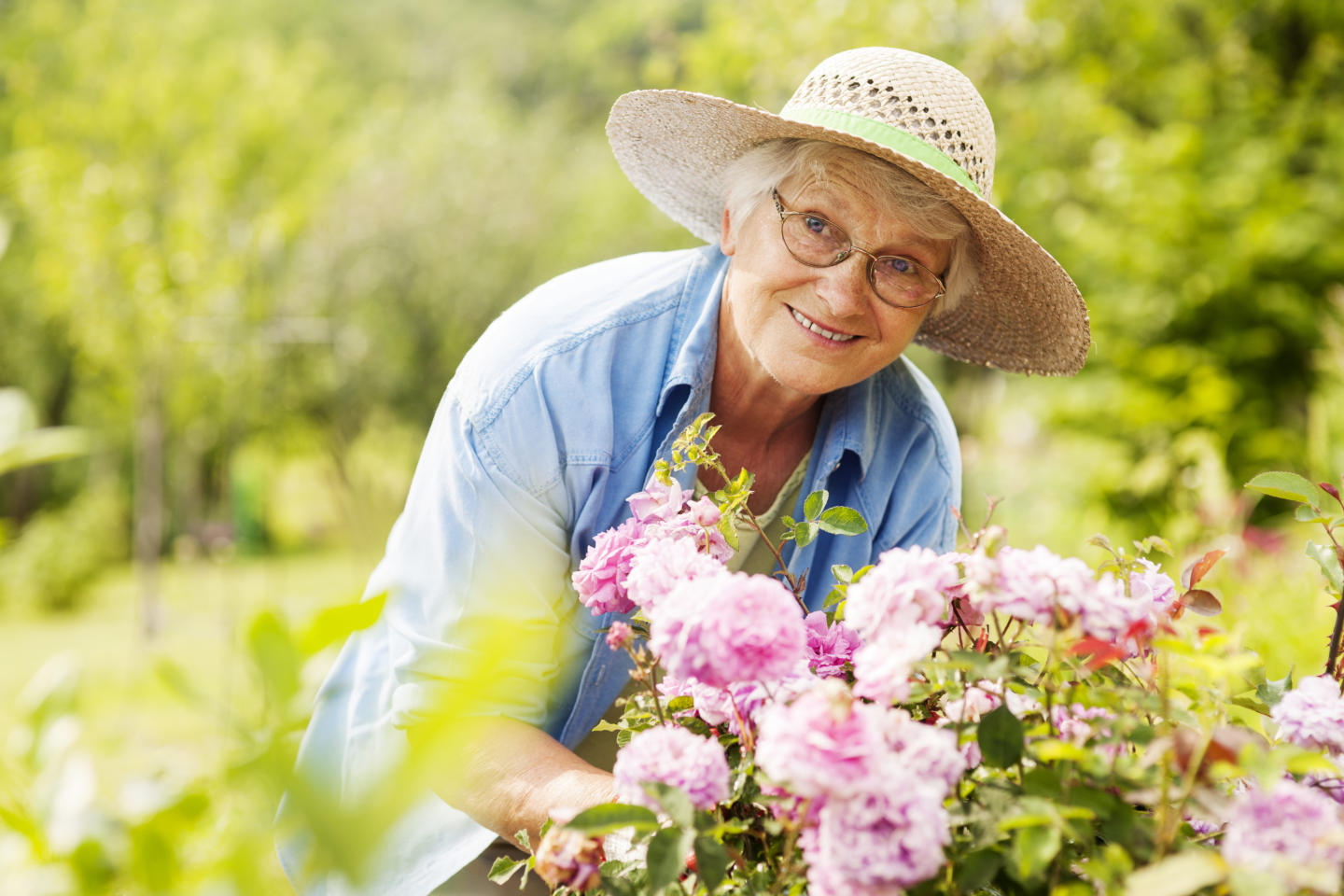 Senior woman in garden with flowers